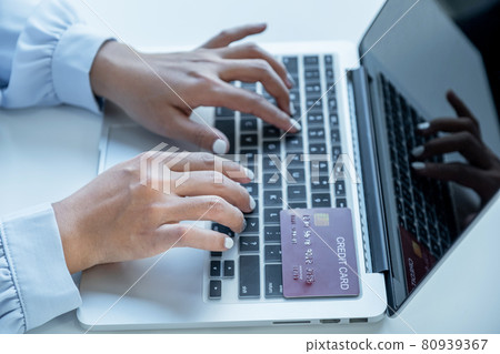 Consumer woman hand use laptop , Ready to a mock up credit card spending pay online finance shopping according to discount products via laptop from home office 80939367