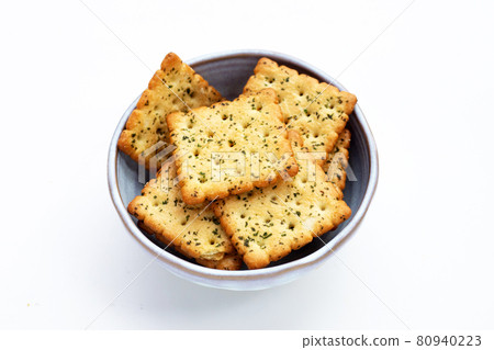 Seaweed crackers in bowl on white background. Seaweed crackers in bowl on white background. 80940223
