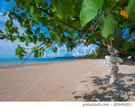 A shallow, quiet tropical beach and a mobile of coral wreckage hung on a tree (Khaorak, Phang Nga Province, Kingdom of Thailand) A shallow, quiet tropical beach and a mobile of coral wreckage hung on a tree (Khaorak, Phang Nga Province, Kingdom of Thailand) 80940801