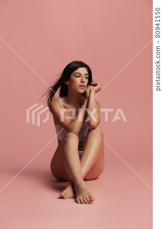 Sports, yoga and healthy lifestyle. Young beautiful sportive woman in lingerie posing isolated over pink studio background. Natural beauty concept. Sports, yoga and healthy lifestyle. Young beautiful sportive woman in lingerie posing isolated over pink studio background. Natural beauty concept. 80941550