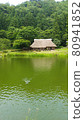 Old folk house with thatched roof on the pond 80941852