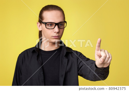 young man in glasses touching virtual screen young man in glasses touching virtual screen 80942375