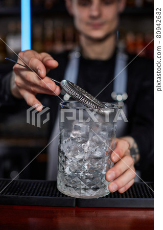 Professional male bartender makes an alcoholic cocktail 80942682