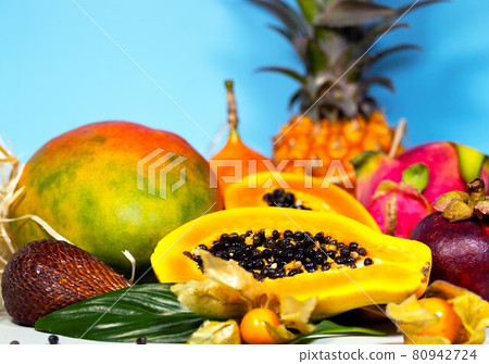 Papaya, Dragon Fruit, Mango, Mangosteen, Winter Cherry, Granadilla, Salak and Pineapple. Fresh Tropical Fruits. On blue background. Top view. Fruit Background 80942724