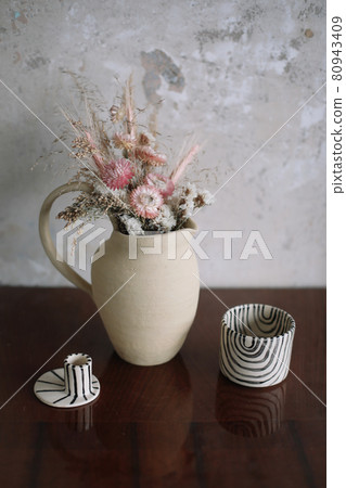 still life with dry flowers in a ceramic vase and a cup. Home decor, interior details still life with dry flowers in a ceramic vase and a cup. Home decor, interior details 80943409