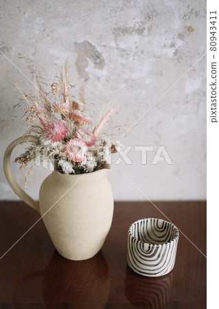 still life with dry flowers in a ceramic vase and a cup. Home decor, interior details still life with dry flowers in a ceramic vase and a cup. Home decor, interior details 80943411