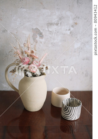 still life with dry flowers in a ceramic vase and a cup. Home decor, interior details still life with dry flowers in a ceramic vase and a cup. Home decor, interior details 80943412