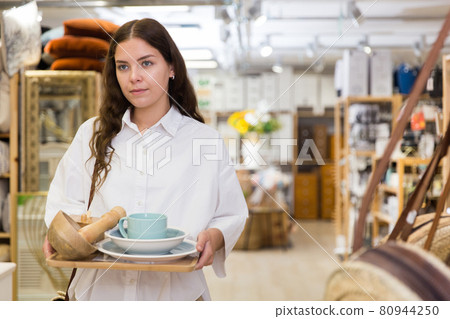 Woman buyer standing in shopping room with decor for home 80944250