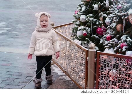 little blond baby girl in admire Christmas tree and decoration full body photo little blond baby girl in admire Christmas tree and decoration full body photo 80944334