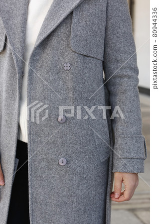 gray woolen coat closeup detail with model hands on city street background gray woolen coat closeup detail with model hands on city street background 80944336