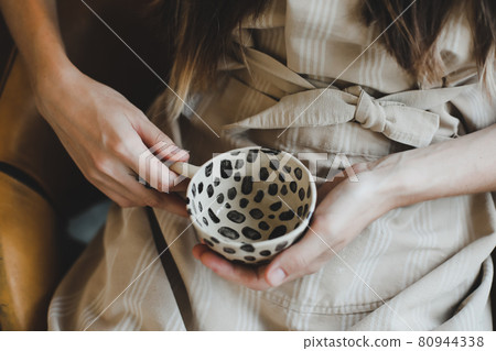 photo of a ceramic cup in female hands close-up photo of a ceramic cup in female hands close-up 80944338