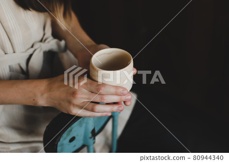photo of a ceramic cup in female hands close-up photo of a ceramic cup in female hands close-up 80944340