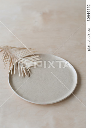 Ceramic plate on a wooden table top view. minimalist handmade ceramic tableware and pottery 80944362