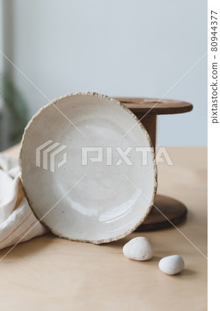 Ceramic bowl on a wooden table top view. Handmade ceramic tableware and pottery Ceramic bowl on a wooden table top view. Handmade ceramic tableware and pottery 80944377
