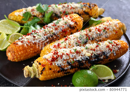 Elotes, Grilled Mexican Street Corn on a plate 80944771