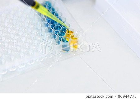 Lab Worker Adding Liquid to Test Tubes 80944773