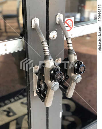 Door handle on gas station made of Gasoline pistol pump fuel nozzle Door handle on gas station made of Gasoline pistol pump fuel nozzle 80944833