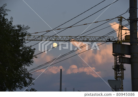 Evening landscape and full moon with a tower crane Evening landscape and full moon with a tower crane 80945086