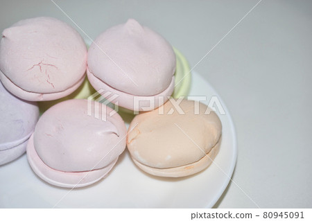 Colorful delicious marshmallows on a white plate Colorful delicious marshmallows on a white plate 80945091