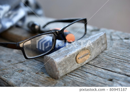 Hammer screwdriver tools and glasses on the board 80945187