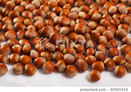 Hazelnuts on white surface Hazelnuts on white surface 80945428