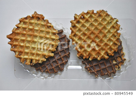 Chocolate round waffle cookies on a white background Chocolate round waffle cookies on a white background 80945549