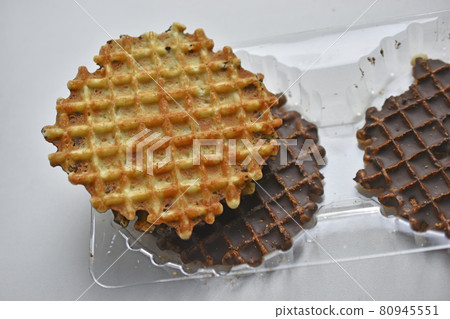 Chocolate round waffle cookies on a white background 80945551