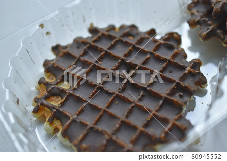 Chocolate round waffle cookies on a white background Chocolate round waffle cookies on a white background 80945552