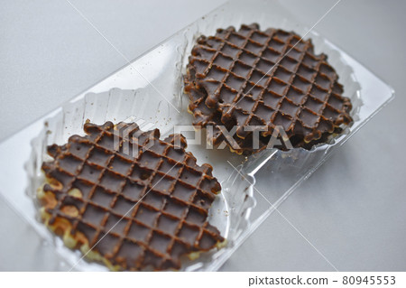 Chocolate round waffle cookies on a white background 80945553