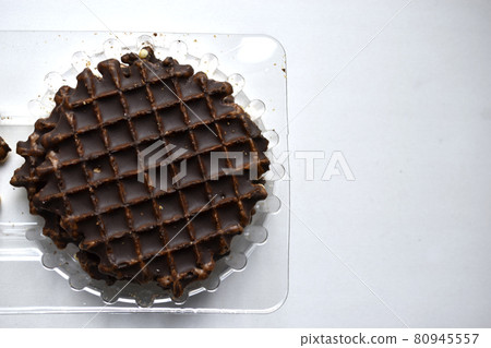 Chocolate round waffle cookies on a white background 80945557