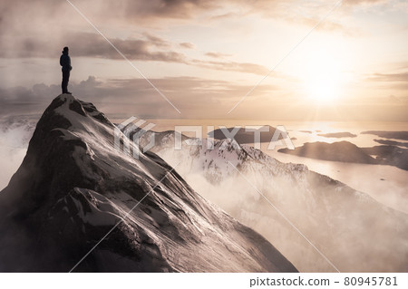Man Standing on top of Rocky Mountain Cliff Man Standing on top of Rocky Mountain Cliff 80945781