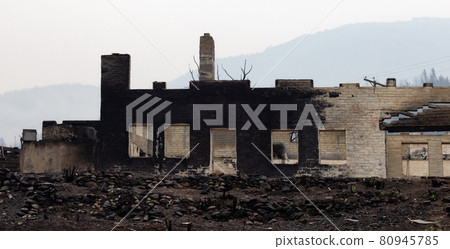Fire Debris of Houses in a small town with smoke in sky. Fire Debris of Houses in a small town with smoke in sky. 80945785