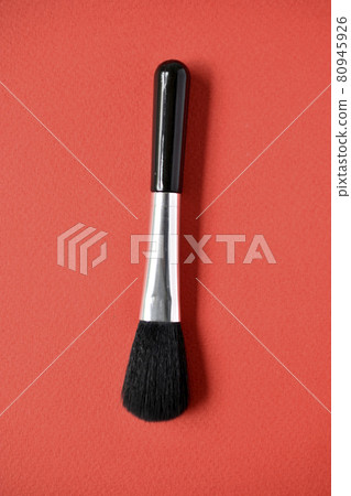 Brush for cleaning optics on a red background 80945926