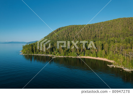 Summertime imagery of Lake Baikal is a rift lake located in southern Siberia, Russia Baikal lake summer landscape view from a cliff near Grandma's Bay. Drone's Eye View. Summertime imagery of Lake Baikal is a rift lake located in southern Siberia, Russia Baikal lake summer landscape view from a cliff near Grandma's Bay. Drone's Eye View. 80947278