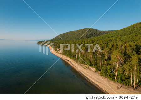 Summertime imagery of Lake Baikal is a rift lake located in southern Siberia, Russia Baikal lake summer landscape view from a cliff near Grandma's Bay. Drone's Eye View. 80947279