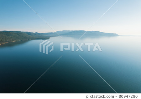 Summertime imagery of Lake Baikal is a rift lake located in southern Siberia, Russia Baikal lake summer landscape view from a cliff near Grandma's Bay. Drone's Eye View. Summertime imagery of Lake Baikal is a rift lake located in southern Siberia, Russia Baikal lake summer landscape view from a cliff near Grandma's Bay. Drone's Eye View. 80947280