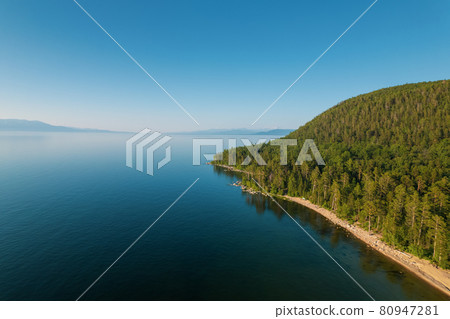 Summertime imagery of Lake Baikal is a rift lake located in southern Siberia, Russia Baikal lake summer landscape view from a cliff near Grandma's Bay. Drone's Eye View. 80947281
