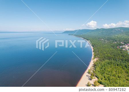 Summertime imagery of Lake Baikal is a rift lake located in southern Siberia, Russia Baikal lake summer landscape view from a cliff near Grandma's Bay. Drone's Eye View. 80947282