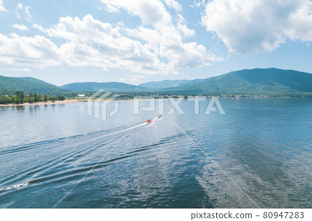 Summertime imagery of Lake Baikal is a rift lake located in southern Siberia, Russia Baikal lake summer landscape view from a cliff near Grandma's Bay. Drone's Eye View. 80947283