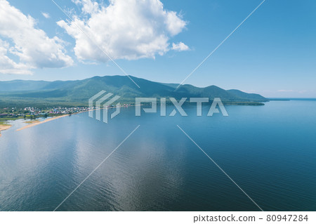 Summertime imagery of Lake Baikal is a rift lake located in southern Siberia, Russia Baikal lake summer landscape view from a cliff near Grandma's Bay. Drone's Eye View. Summertime imagery of Lake Baikal is a rift lake located in southern Siberia, Russia Baikal lake summer landscape view from a cliff near Grandma's Bay. Drone's Eye View. 80947284
