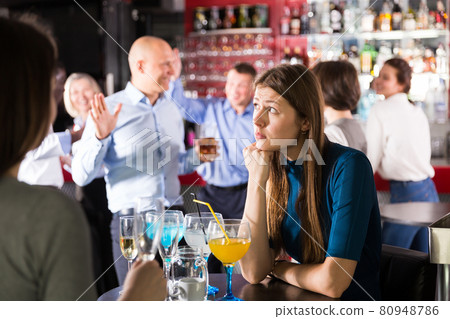 Upset young woman at corporate bar party Upset young woman at corporate bar party 80948786