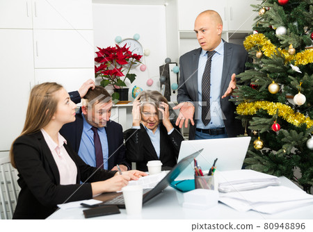 Worried team working at office Worried team working at office 80948896