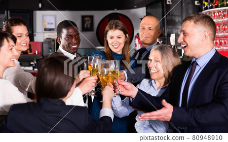 International group of businesspeople toasting with champagne, having fun at office party in nightclub International group of businesspeople toasting with champagne, having fun at office party in nightclub 80948910