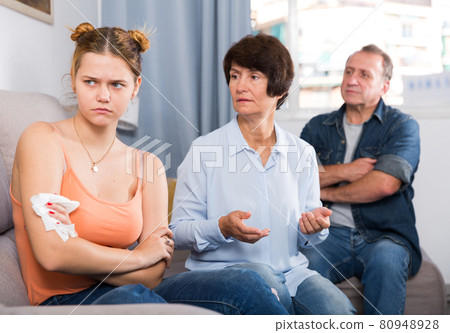 Mom and dad are supporting a sad daughter on sofa Mom and dad are supporting a sad daughter on sofa 80948928