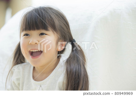 Girl playing wrapped in sheets 80949969