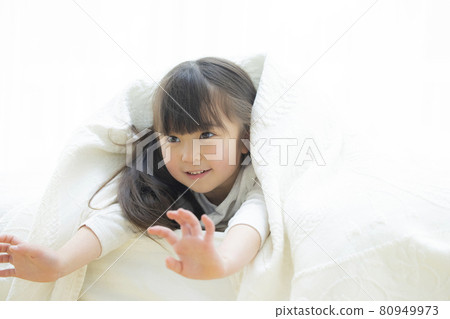Girl playing wrapped in sheets 80949973