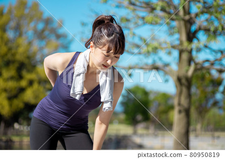 A woman who exercises and hurts her back A woman who exercises and hurts her back 80950819