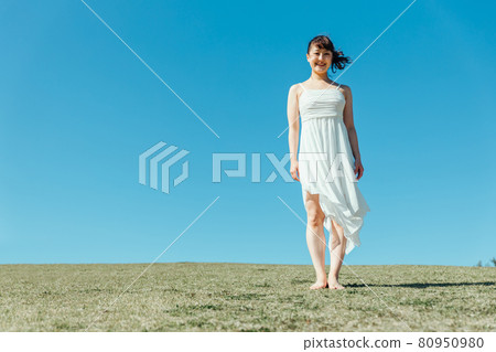 Woman in sky and white one piece Woman in sky and white one piece 80950980