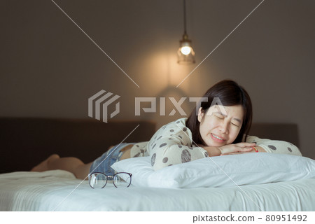 Asian woman sleeping and grinding teeth at bedroom,Female tiredness and stress 80951492