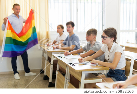 Teenage schoolgirl listening to teacher talking about LGBT at lesson 80952166